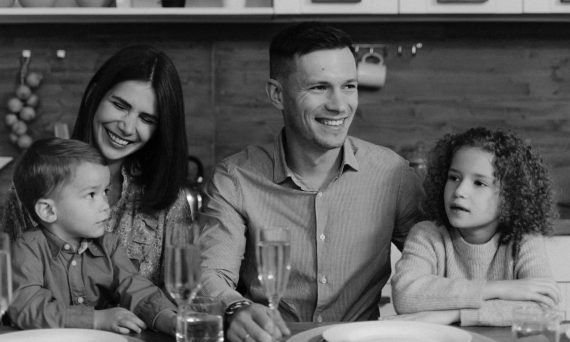 Smiling family enjoying quality time together at dining table in cozy kitchen.