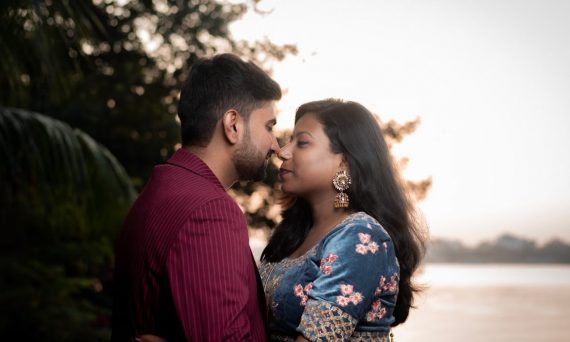 Captivating pre-wedding moment with a couple in India by the riverside at sunset.